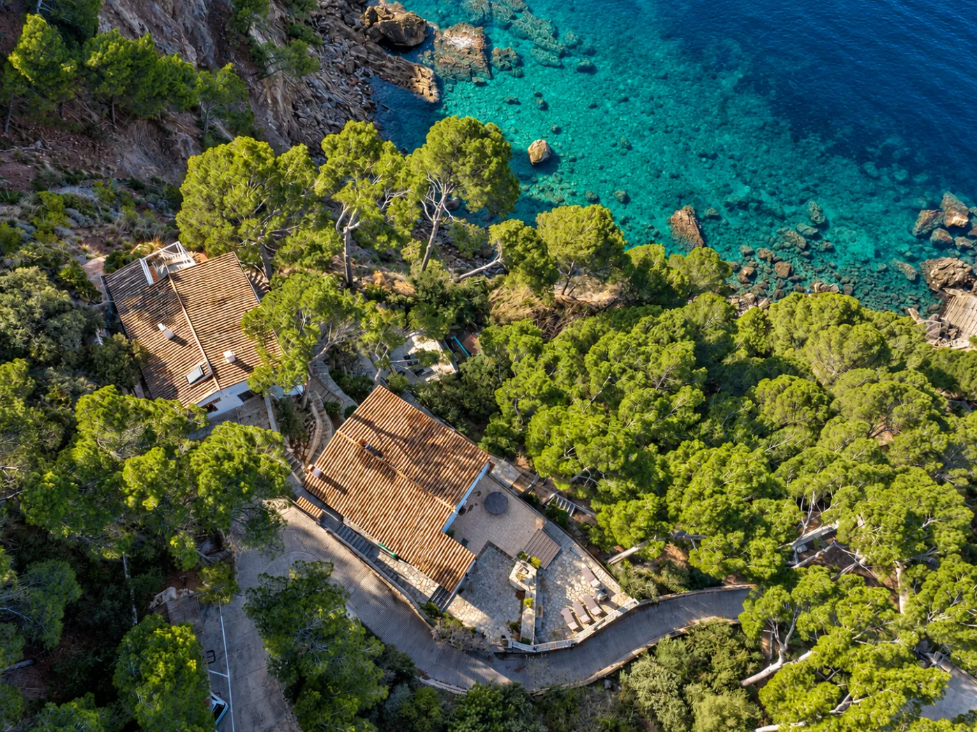 Cliffside Balearic villas above a turquoise cove