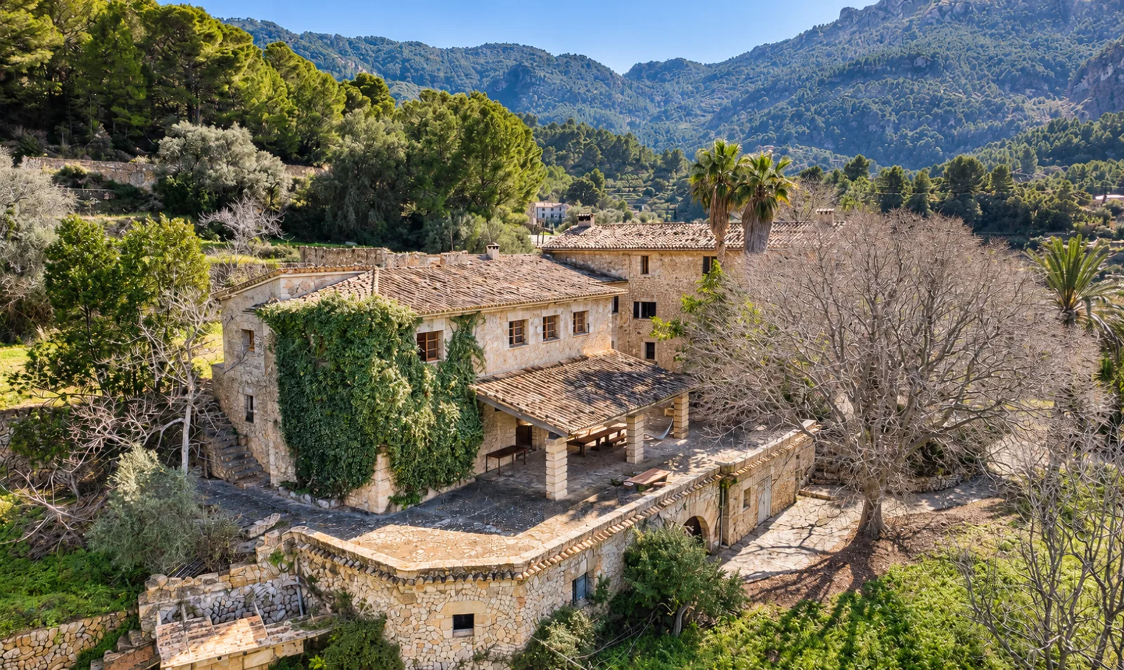 Historic stone finca beneath mountain slopes